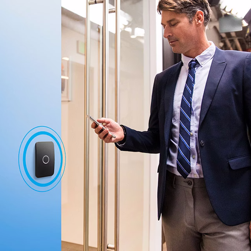 Man in suit using smartphone indoors.